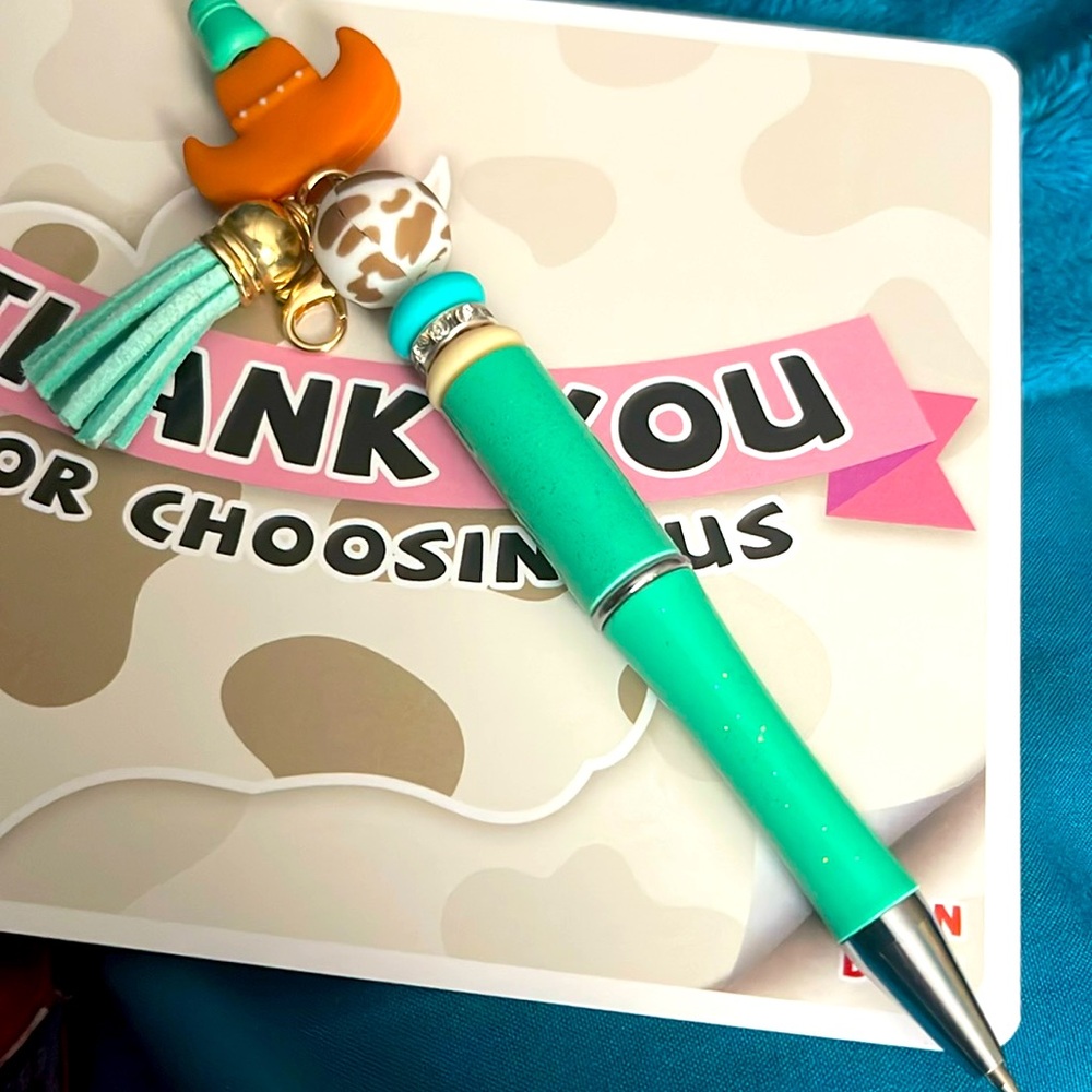 Pen made of decorative silicone beads, and teal tassel. Black ink & retractable